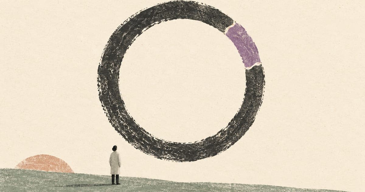 A clinician beneath an imperfect ring whose broken section has been visibly repaired