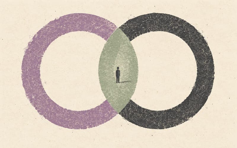 Two large contrasting circles sharing a narrow central space around a tiny figure